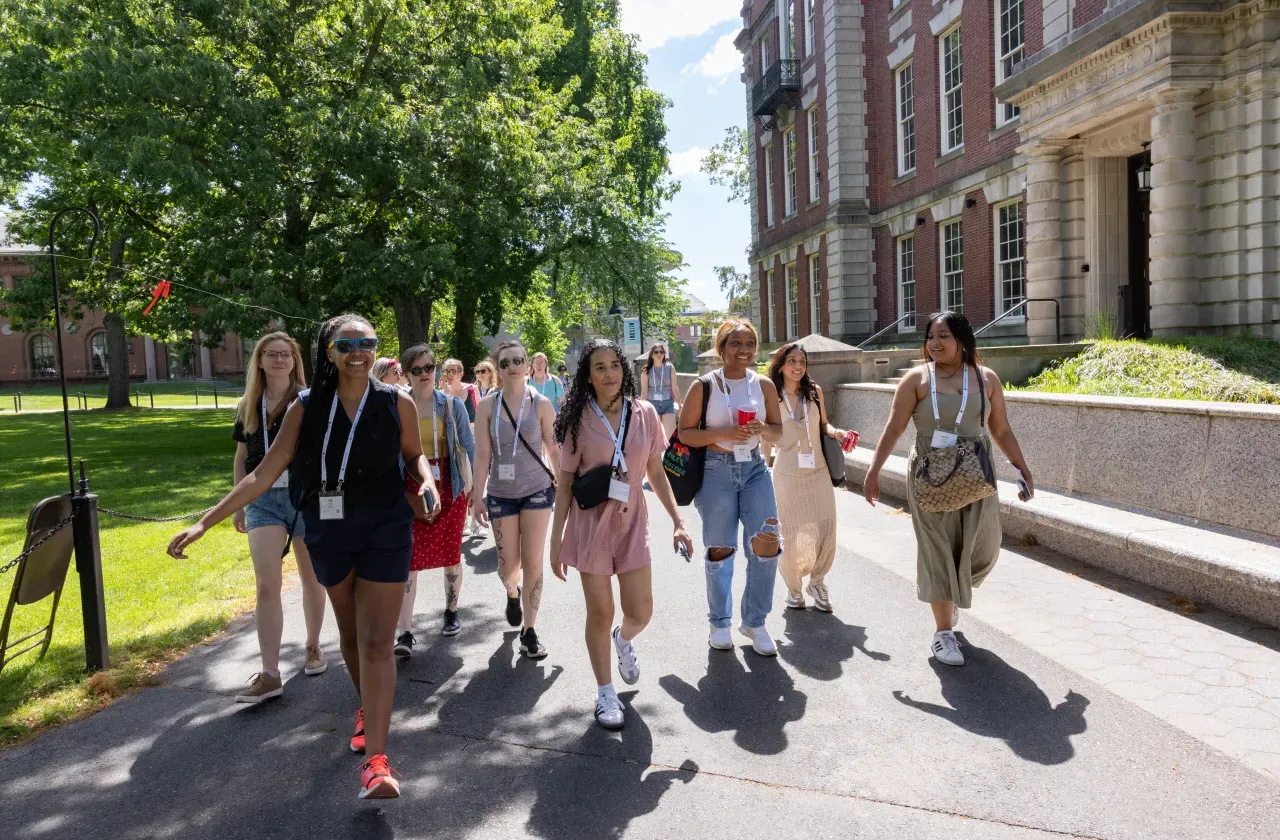 A group of alums walking in front of Seelye Hall